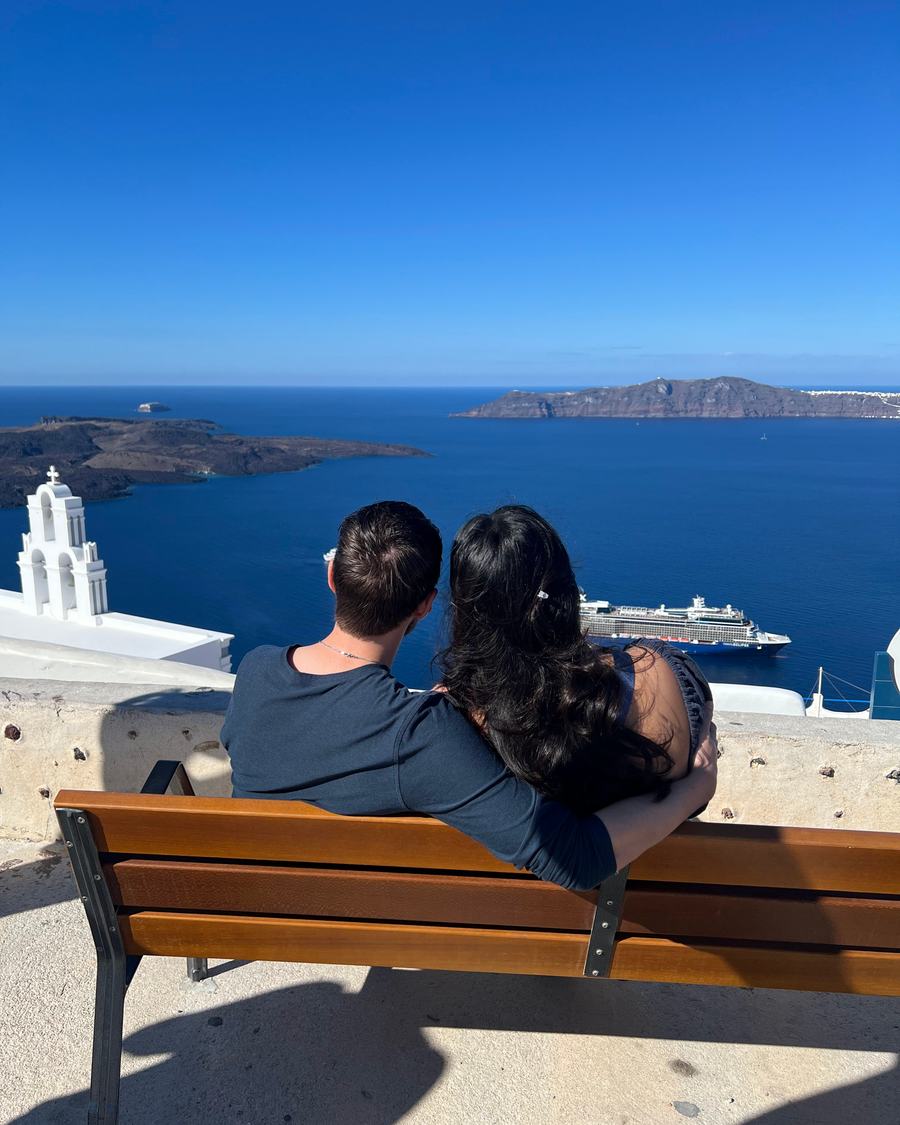 Megan and Tyler on a bench overlooking the sea